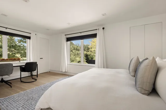 a bedroom with a bed and a chair