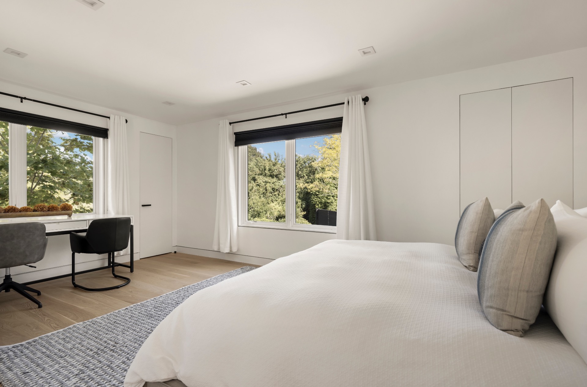 1076 Ocean Road Bridgehampton, NY 11932 - Photo 22 of 35 a bedroom with a bed and a chair