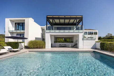 a view of an empty room with fireplace and a window