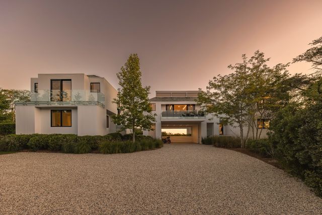 a front view of a house with a yard and a garage
