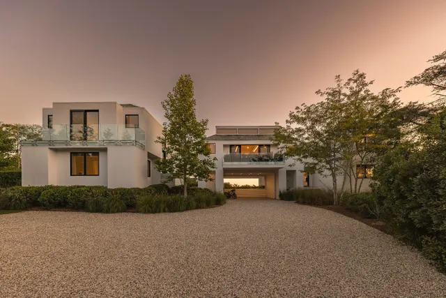 a front view of a house with a yard and a garage