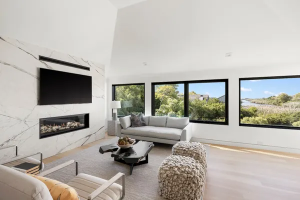 a living room with furniture a flat screen tv and a fireplace