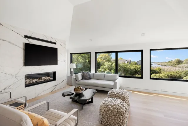 a living room with furniture a flat screen tv and a fireplace