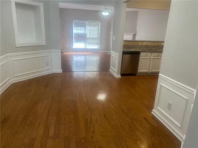 en empty room with windows and fireplace