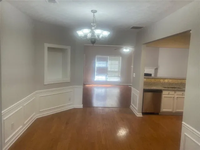 a kitchen with a white cabinets and window