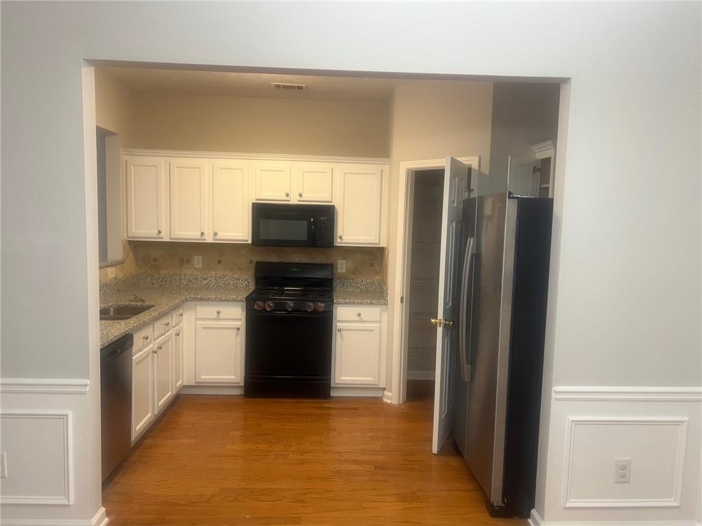 3809 Dandridge Way Northwest Duluth, GA 30096 - Photo 6 of 12 a kitchen with a refrigerator stove and microwave