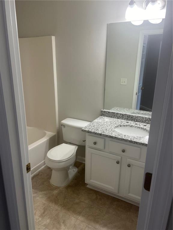3809 Dandridge Way Northwest Duluth, GA 30096 - Photo 10 of 12 a bathroom with a granite countertop toilet sink and mirror