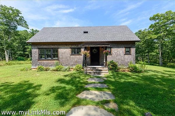 16 Red Coat Hill Road West Tisbury, MA 02568 - Photo 7 of 13 a front view of a house with a yard