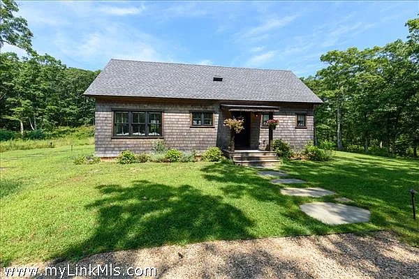 16 Red Coat Hill Road West Tisbury, MA 02568 - Photo 9 of 13 a front view of a house with a yard