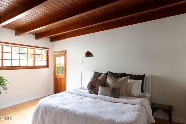 a bedroom with bed and window