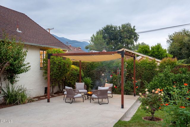 a view of a patio with table and chairs and potted plants