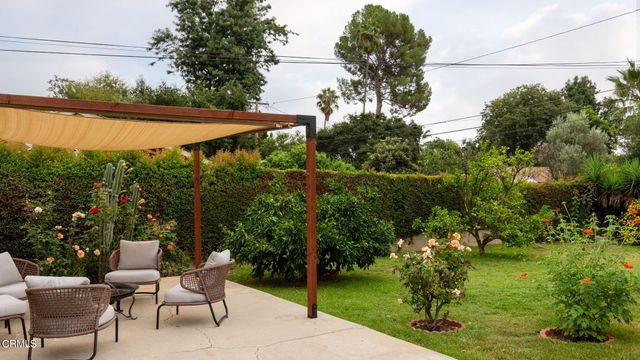 a view of yard with furniture and garden