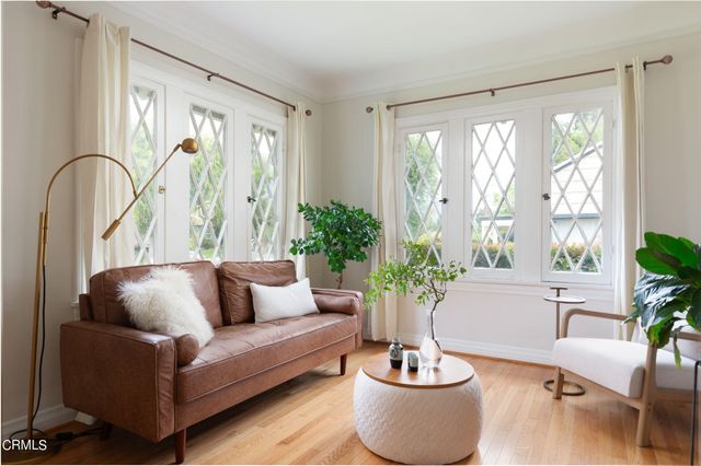 a living room with furniture and a potted plant