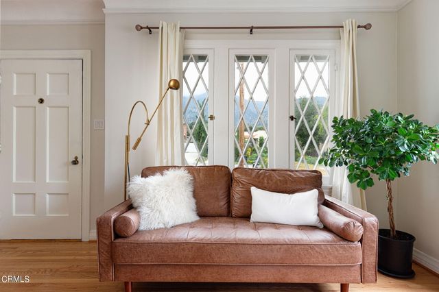 a large couch sitting in a bedroom next to a window