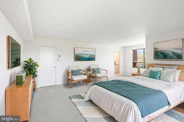 an empty room with a window and a ceiling fan