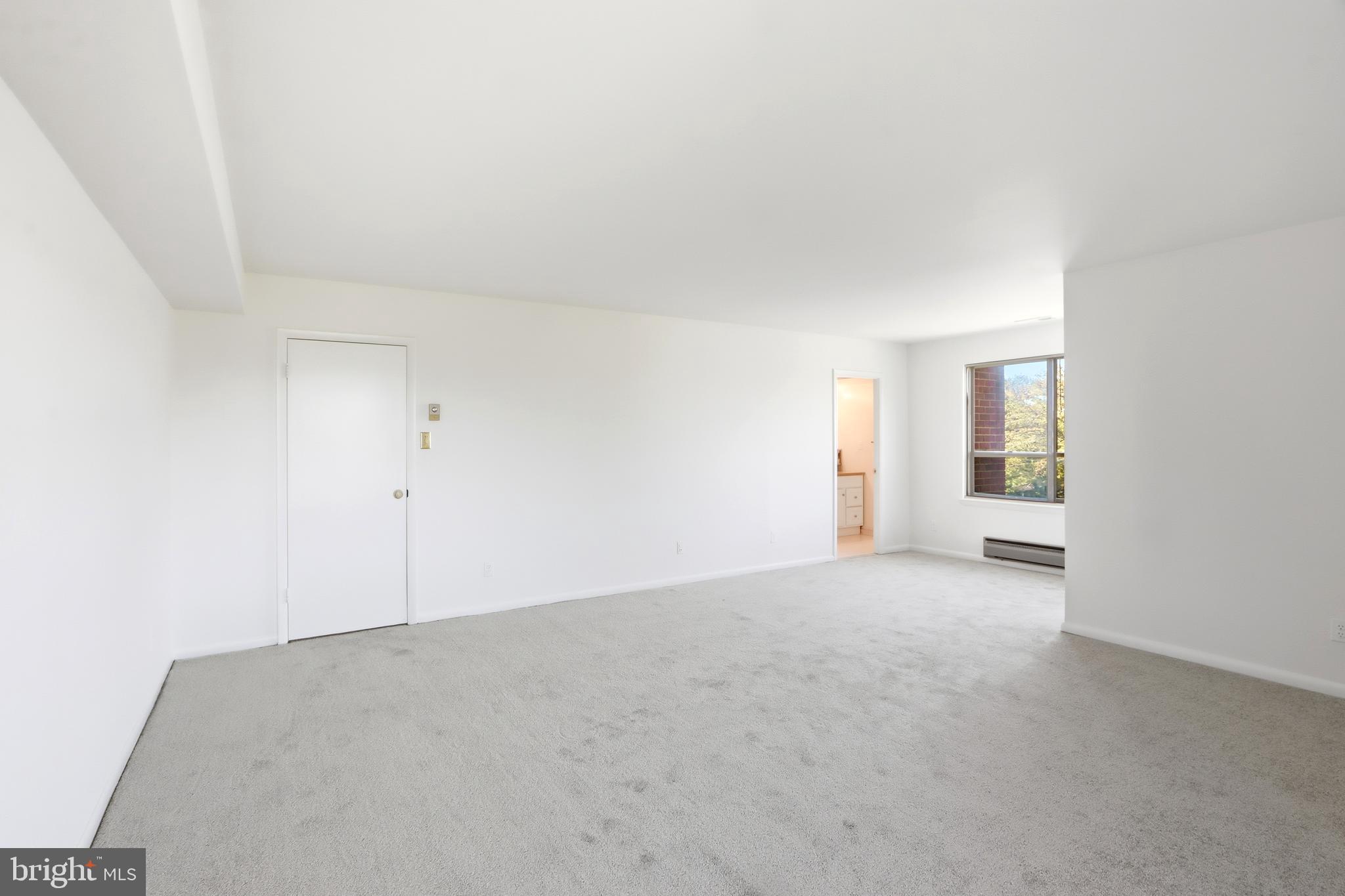 6317 Park Heights Avenue, Unit 404 Baltimore, MD 21215 - Photo 15 of 27 an empty room with windows