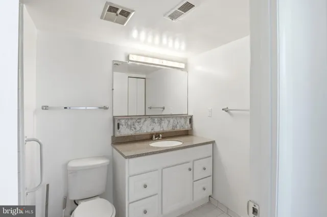 a bathroom with a granite countertop shower and a sink