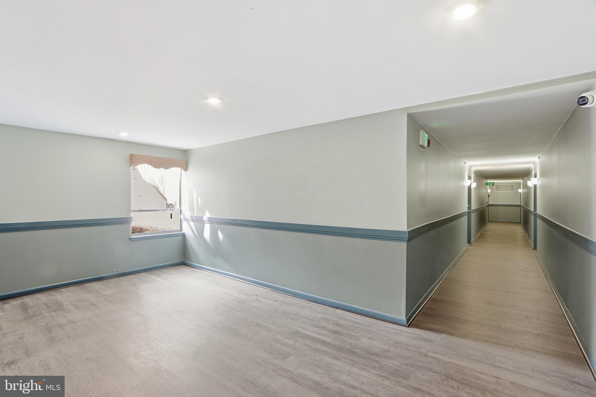 6317 Park Heights Avenue, Unit 404 Baltimore, MD 21215 - Photo 21 of 27 wooden floor in an empty room with a window