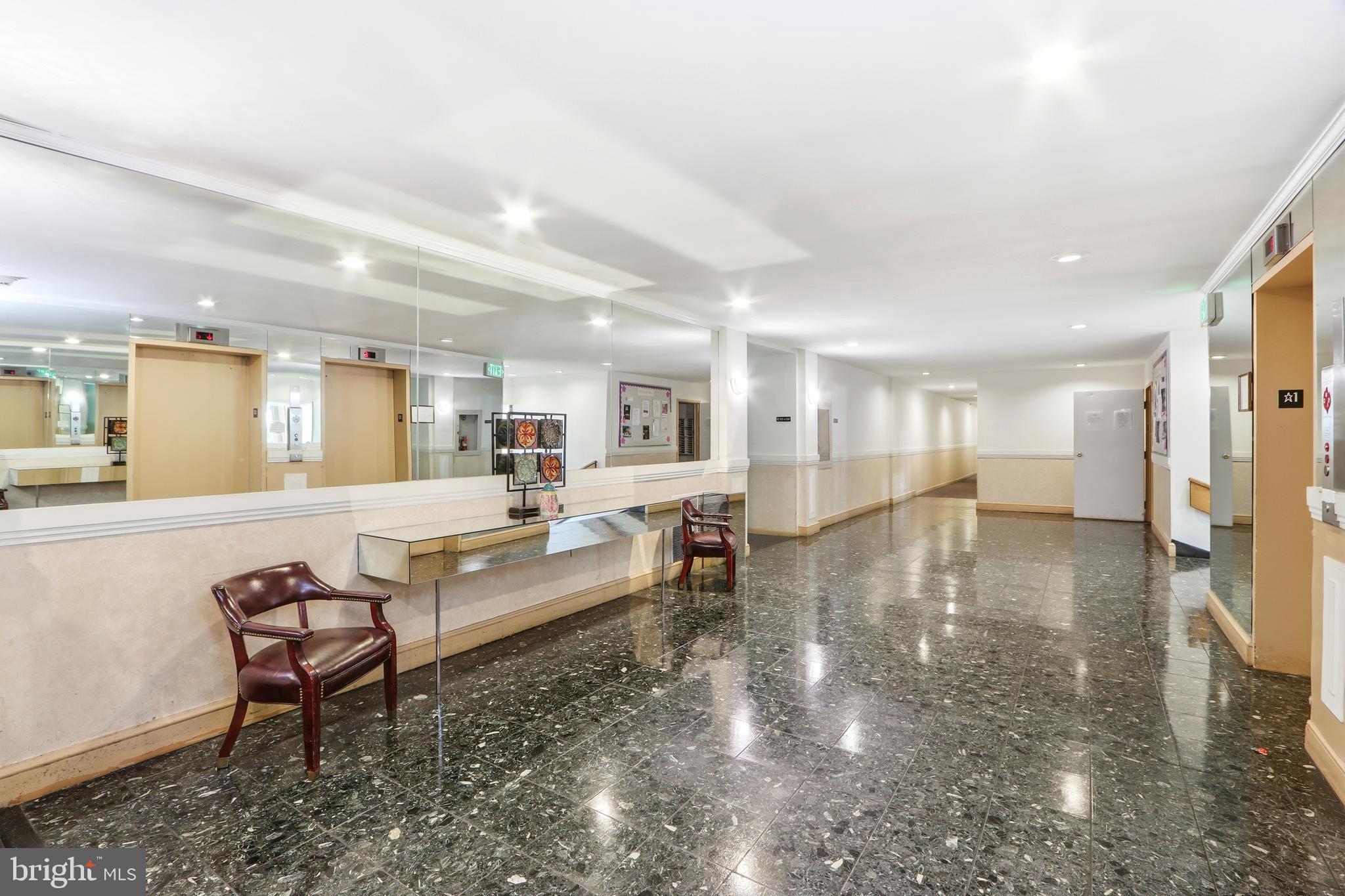 6317 Park Heights Avenue, Unit 404 Baltimore, MD 21215 - Photo 26 of 27 a living room with furniture and a table