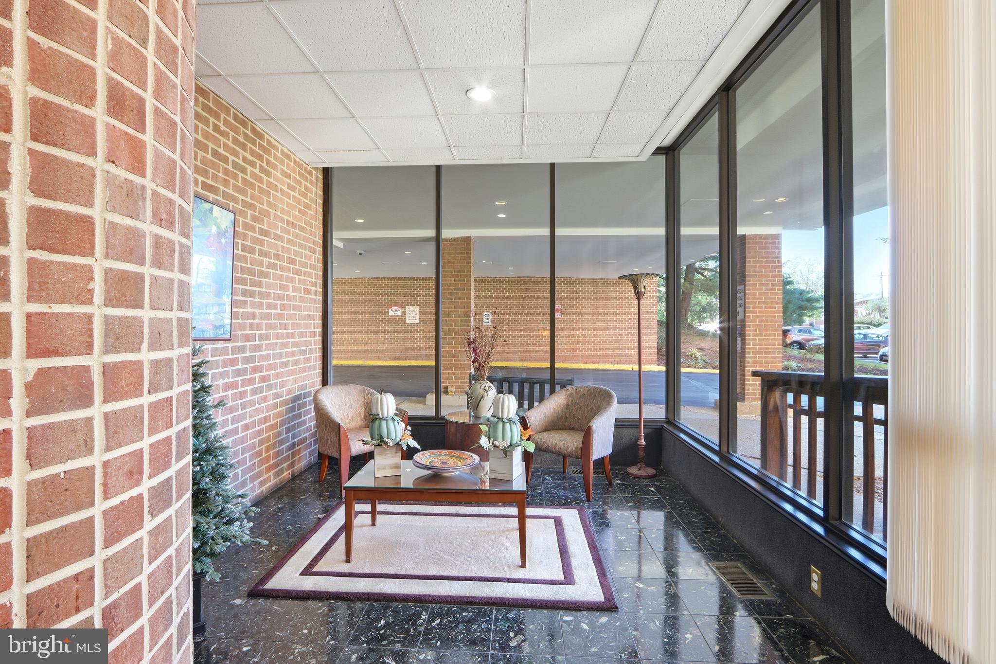 6317 Park Heights Avenue, Unit 404 Baltimore, MD 21215 - Photo 27 of 27 a living room with furniture and a floor to ceiling window