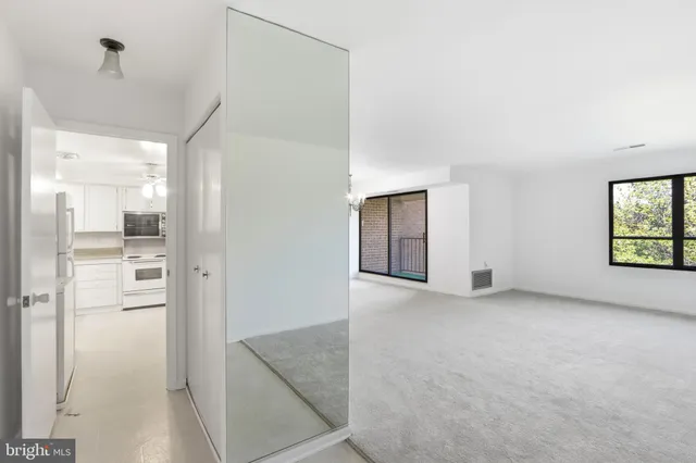 an empty room with windows and closet