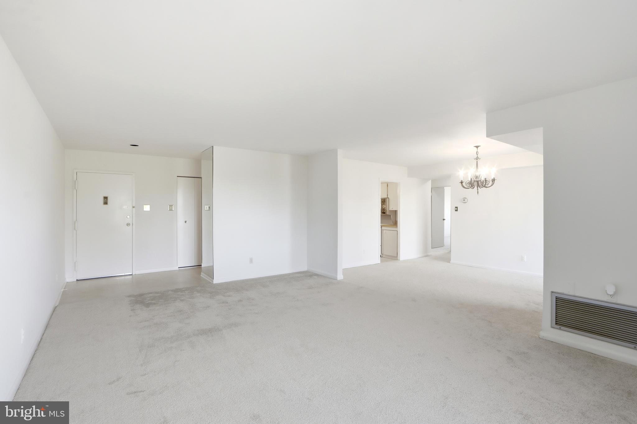 6317 Park Heights Avenue, Unit 404 Baltimore, MD 21215 - Photo 4 of 27 a view of a big room with windows and chandelier fan