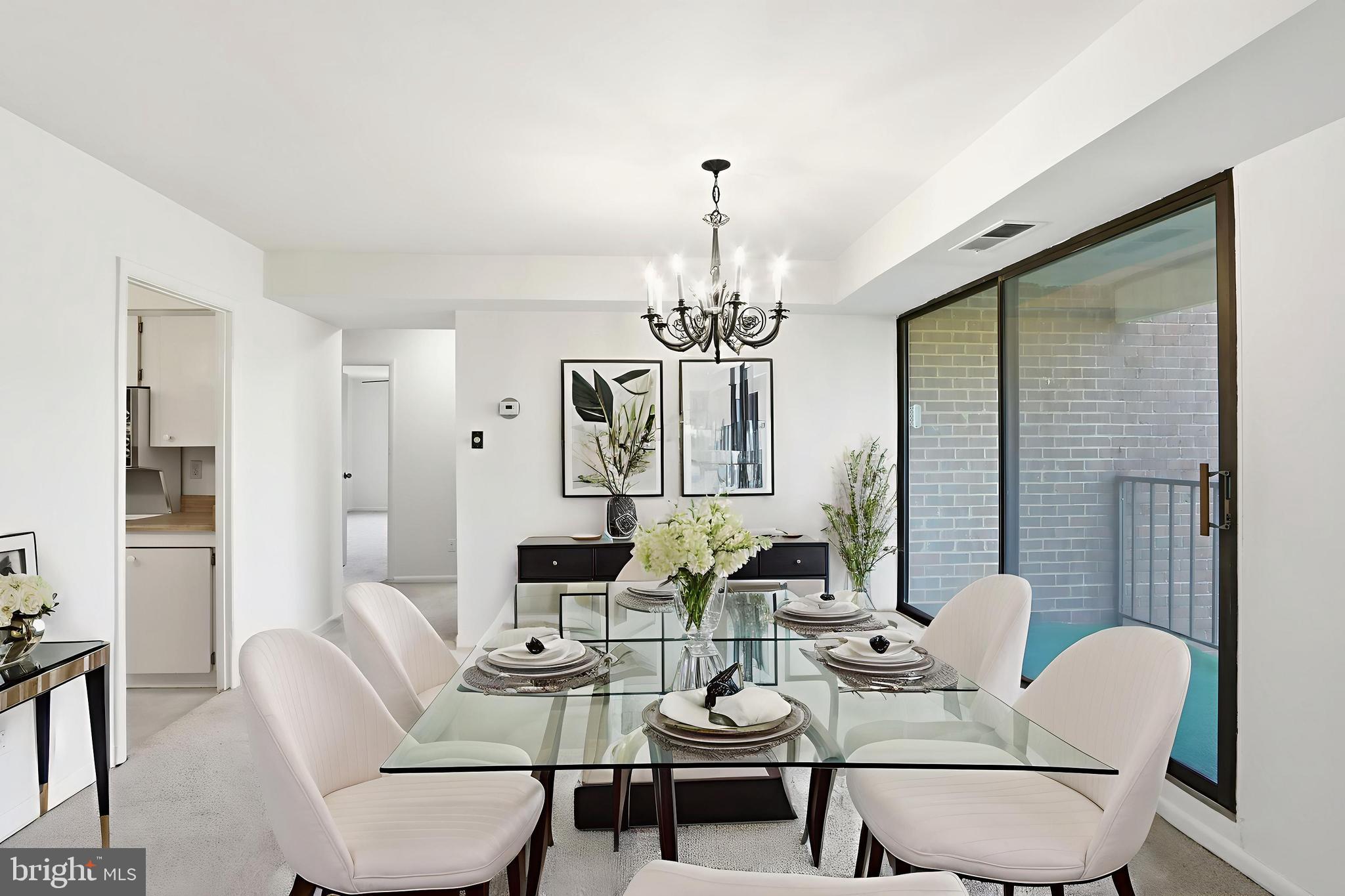 6317 Park Heights Avenue, Unit 404 Baltimore, MD 21215 - Photo 5 of 27 a view of a dining room with furniture a chandelier and wooden floor