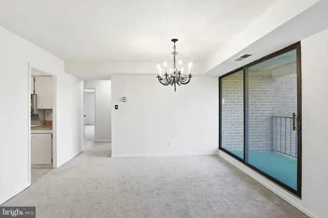 a view of a hallway with a chandelier