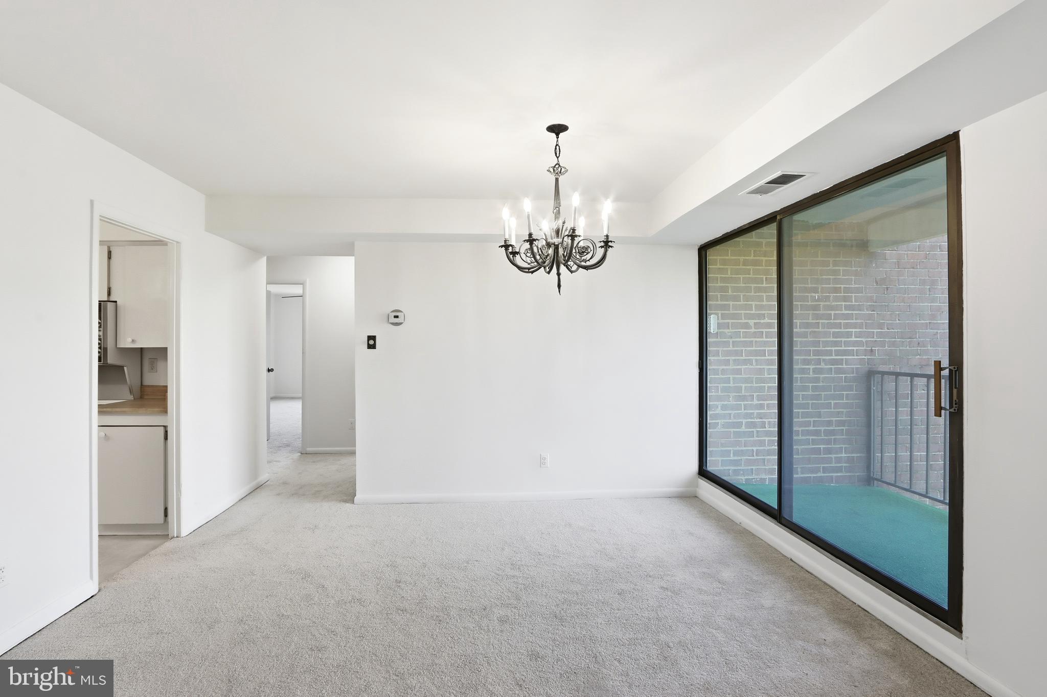 6317 Park Heights Avenue, Unit 404 Baltimore, MD 21215 - Photo 6 of 27 a view of a hallway with a chandelier