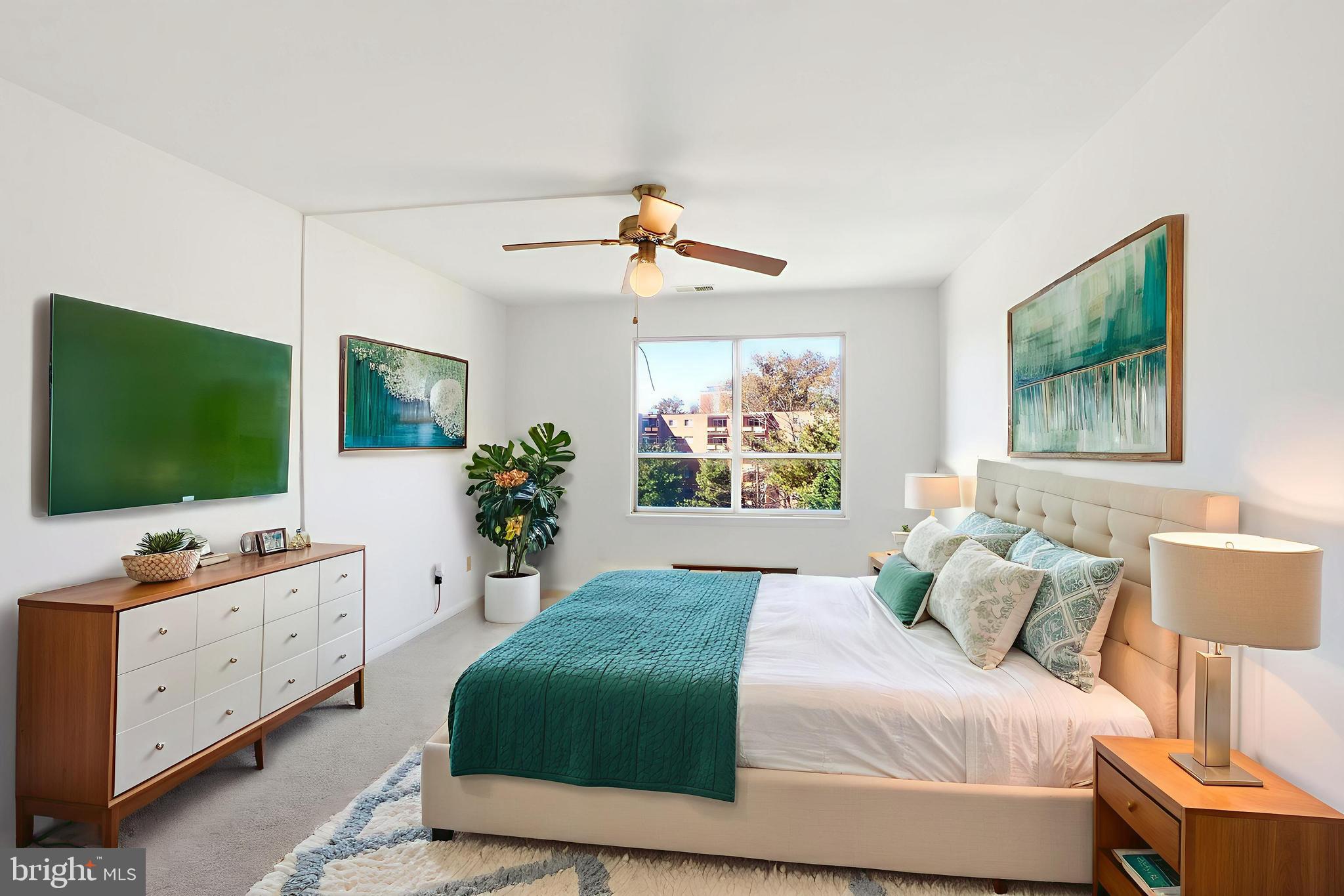 6317 Park Heights Avenue, Unit 404 Baltimore, MD 21215 - Photo 9 of 27 a bedroom with a bed window and flat screen tv