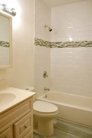 a bathroom with a toilet a sink and bathtub
