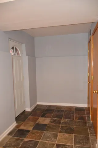 a view of a room with an empty space and a window