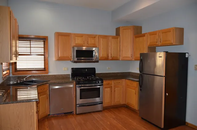 a kitchen with a refrigerator stove and microwave