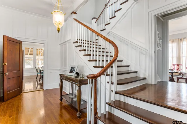 a view of entryway and hall with wooden floor