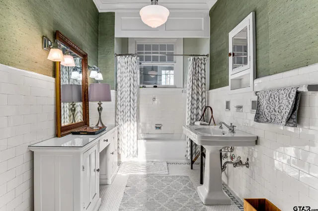 a bathroom with a sink a mirror and a shower