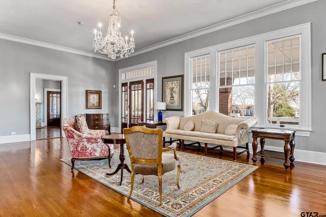 a living room with furniture and a chandelier