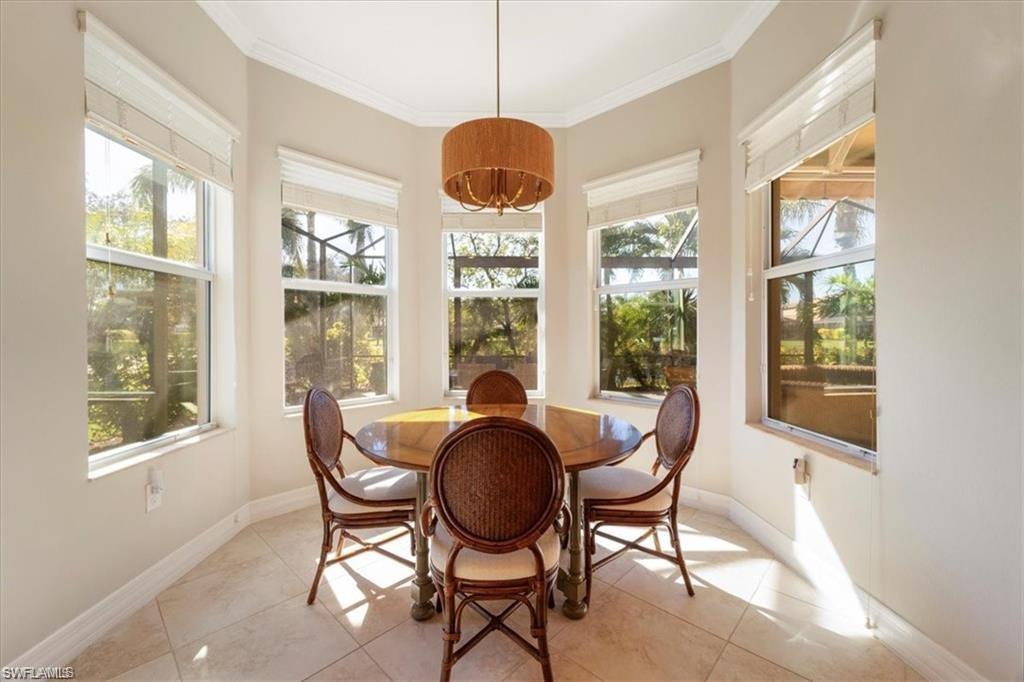 6670 Marbella Lane Naples, FL 34105 - Photo 11 of 24 a dining room with furniture window and outside view