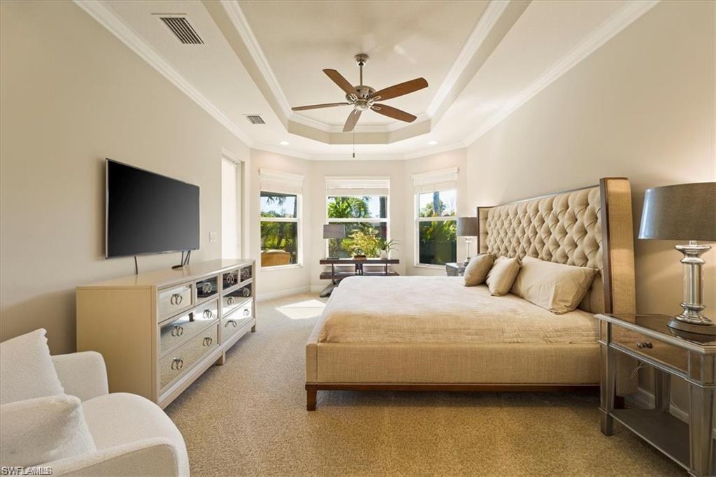 6670 Marbella Lane Naples, FL 34105 - Photo 13 of 24 a spacious bedroom with a bed and a flat screen tv