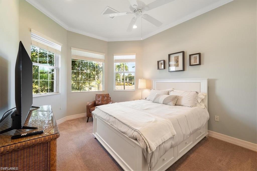 6670 Marbella Lane Naples, FL 34105 - Photo 15 of 24 a bedroom with a large bed and a window