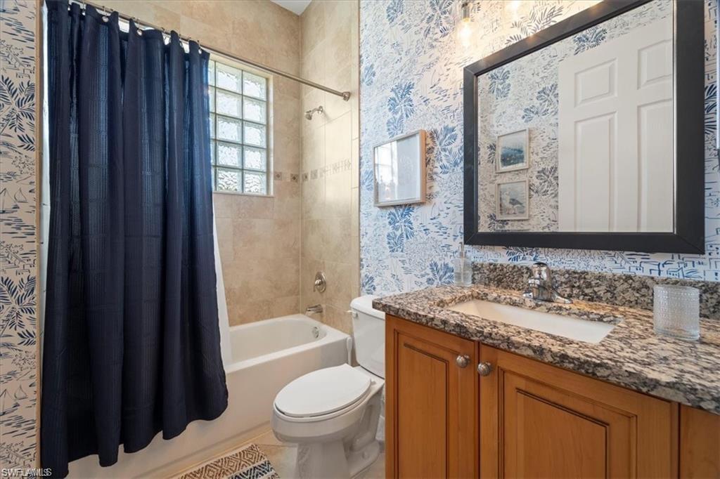6670 Marbella Lane Naples, FL 34105 - Photo 16 of 24 a bathroom with a granite countertop sink toilet and shower
