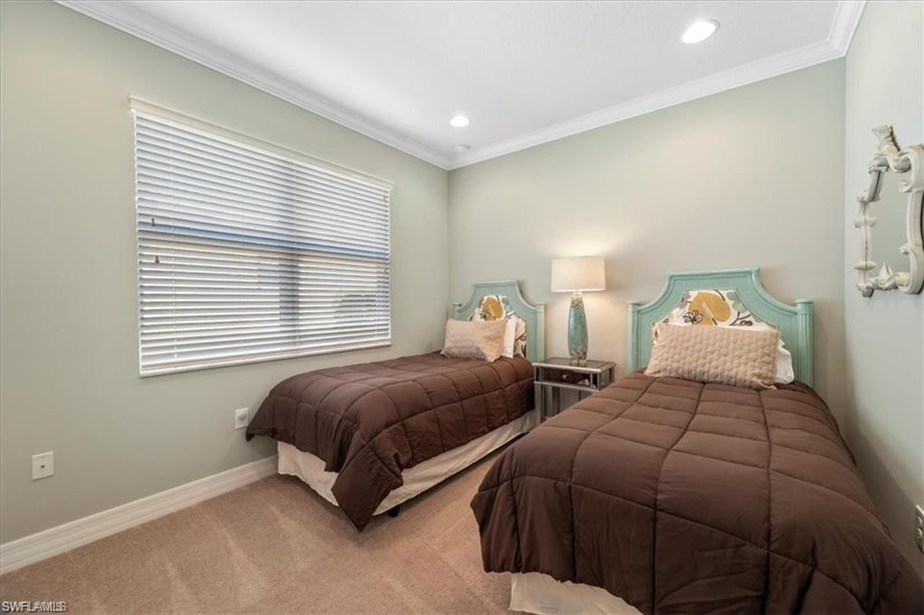 6670 Marbella Lane Naples, FL 34105 - Photo 17 of 24 a bedroom with two beds and a window