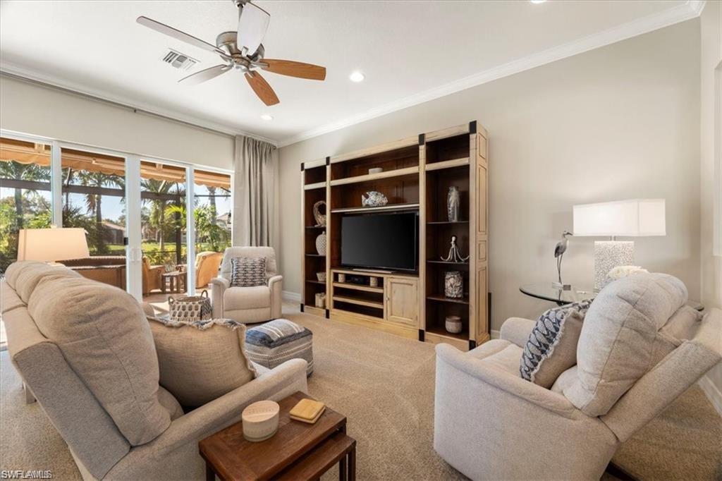 6670 Marbella Lane Naples, FL 34105 - Photo 5 of 24 a living room with furniture and a flat screen tv