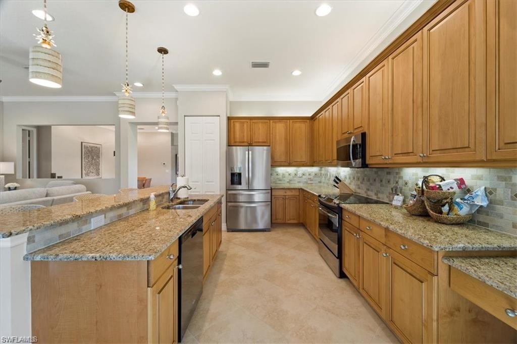 6670 Marbella Lane Naples, FL 34105 - Photo 7 of 24 a kitchen with granite countertop a sink and counter top space