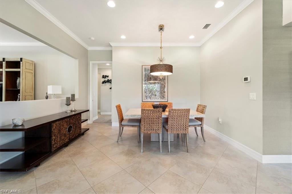 6670 Marbella Lane Naples, FL 34105 - Photo 9 of 24 a large kitchen with a table and chairs