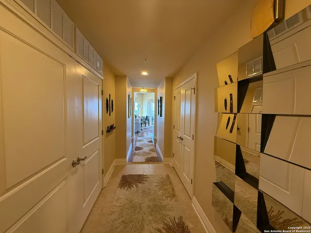 a view of a hallway with a bathroom