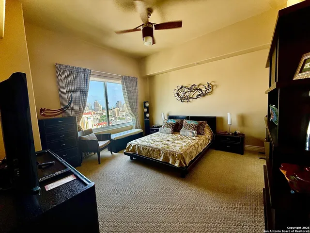 a bedroom with a bed dresser and a flat screen tv