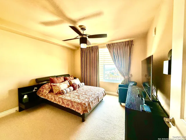 a bedroom with a bed couch and a window