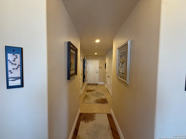 a view of hallway with wooden floor