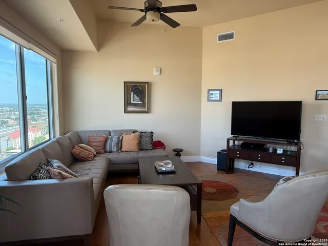 a living room with furniture and a flat screen tv