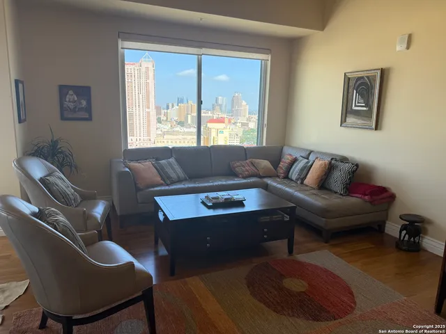 a living room with furniture and a large window